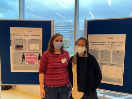 Adna Bliek (left) and Stella Hao (right) in front of research posters