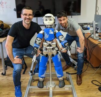 picture showing two people with the humanoid robot iCup in the middle